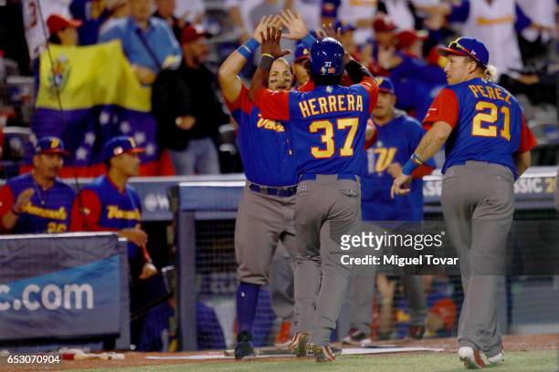 Odubel Herrera of Venezuela celebrates after scoring in the top of the sixth inning during the World Baseball Classic Pool D Game 7 between Venezuela...