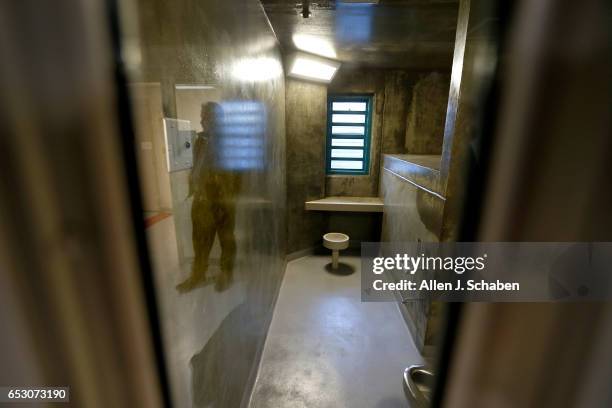 Randy Neitzke, Beverly Hills Police jail supervisor, is reflected in the window of a women's pay to stay individual jail cell. The Beverly Hills...