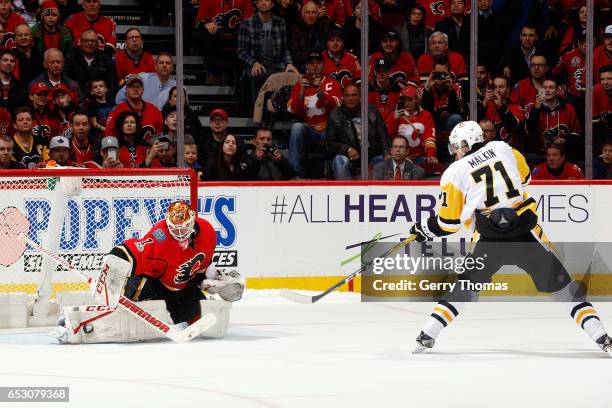 Brian Elliott of the Calgary Flames makes a shootout save against Evgeni Malkin of the Pittsburgh Penguins during an NHL game on March 13, 2017 at...