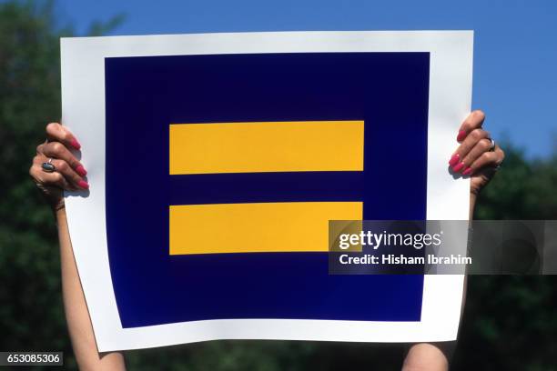 young woman holding equality sign - washington dc, usa - segno di uguale foto e immagini stock