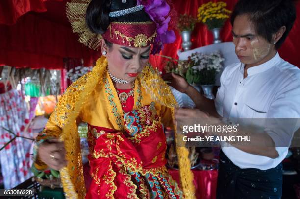 In this photo taken on March 7 a medium gets dressed inside a shrine in Shwe Ku Ni village as he prepares to participate in the Ko Gyi Kyaw Nat...