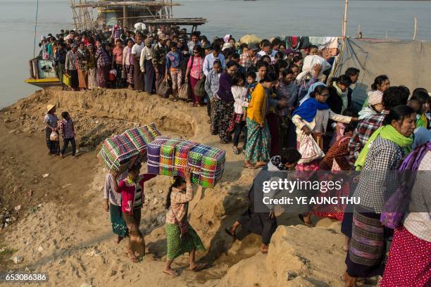 In this photo taken on March 7 people crowd the banks of the Chindwin river in central Myanmar near Pakhangyi town after disembarking from a ferry as...