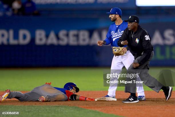 Daniel Descalso of Italy tags out Carlos Gonzalez of Venezuela in the top of the ninth inning during the World Baseball Classic Pool D Game 7 between...