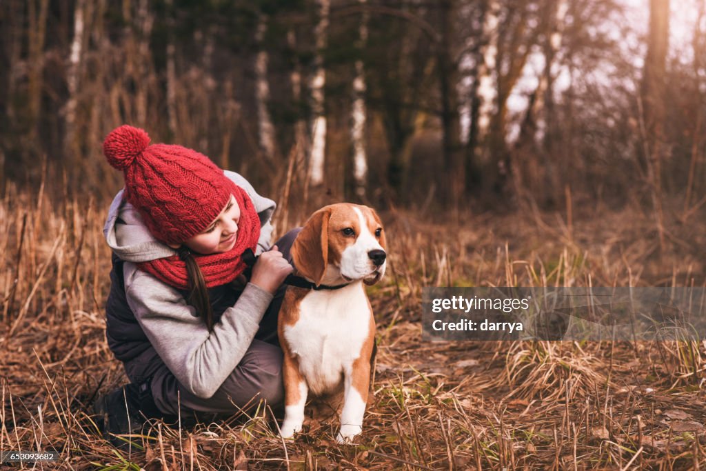 Teenage girl walking with her dog