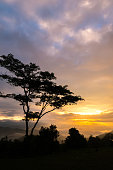 Sun shining through the clouds with silhouetted mountians at Mae Moei National Park,Tak province,Thailand,defocused