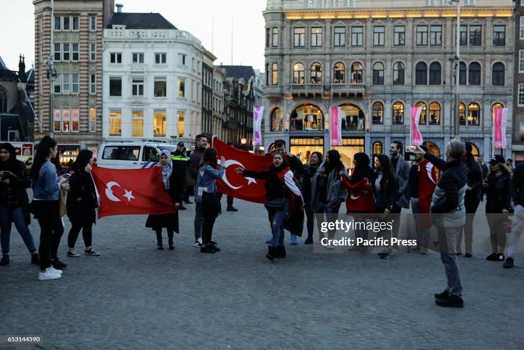 Turkish activists protest with Turkish flags at Dam Square.