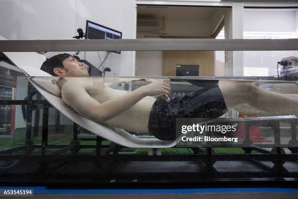 Researcher, wearing active marker motion sensors and electrodes for an electroencephalogram , while conducting bathing tests inside the bathroom...