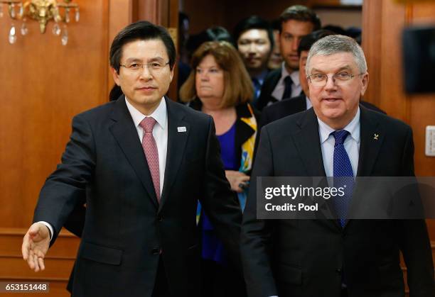 President of the International Olympic Committee Thomas Bach enters a room for a meeting with South Korea's Prime Minister and acting President Hwang...