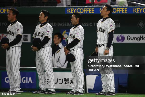 Manager Hiroki Kokubo of Japan line up for the national anthem prior to the World Baseball Classic Pool E Game Four between Cuba and Japan at the...