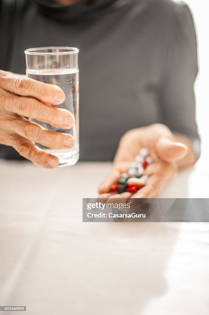 Senior Woman Taking Daily Medicine