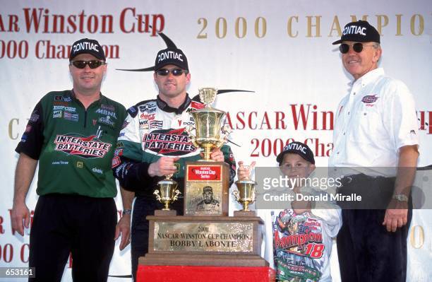 Driver Bobby Labonte poses with Joe Gibbs after winning the Pennzoil 400, part of the NASCAR Winston Cup Series at the Homestead Miami Speedway in...