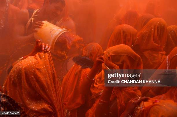 Indian revellers take part in the game of 'Huranga' at The Dauji Temple in Mathura, some 100 kms south of New Delhi on March 14, 2017. - 'Huranga' is...