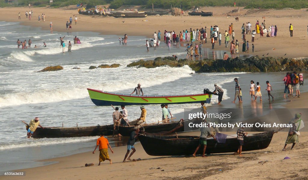 Morning activity on Gokarna beach. Fishermen and pilgrims in Gokarna, Karnataka, India