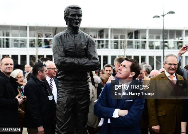 Sir A.P. McCoy poses alongside a statue of himself which was unveiled during Champion Day of the Cheltenham Festival at Cheltenham Racecourse on...