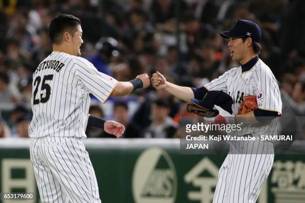 Outfielder Yoshitomo Tsutsugoh of Japan high fives with Outfielder Shogo Akiyama after hitting a RBI single after the bottom of the third inning the...