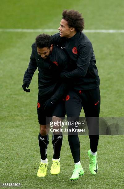 Gael Clichy of Manchester City and Leroy Sane of Manchester City share a smile during a Manchester City training session prior to the UEFA Champions...