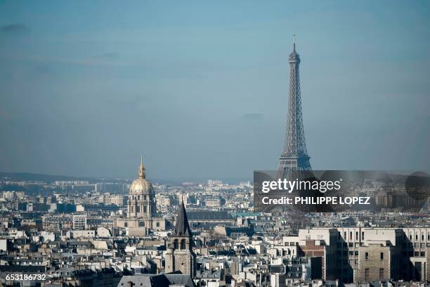 The Eiffel Tower and the dome of Les Invalides, are seen along the skyline of the French capital Paris from the tower at the Notre Dame Cathedral on...