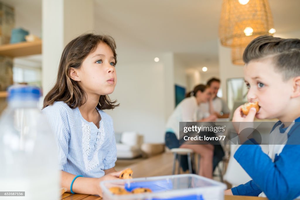 Brother and sister enjoy fresh muffins