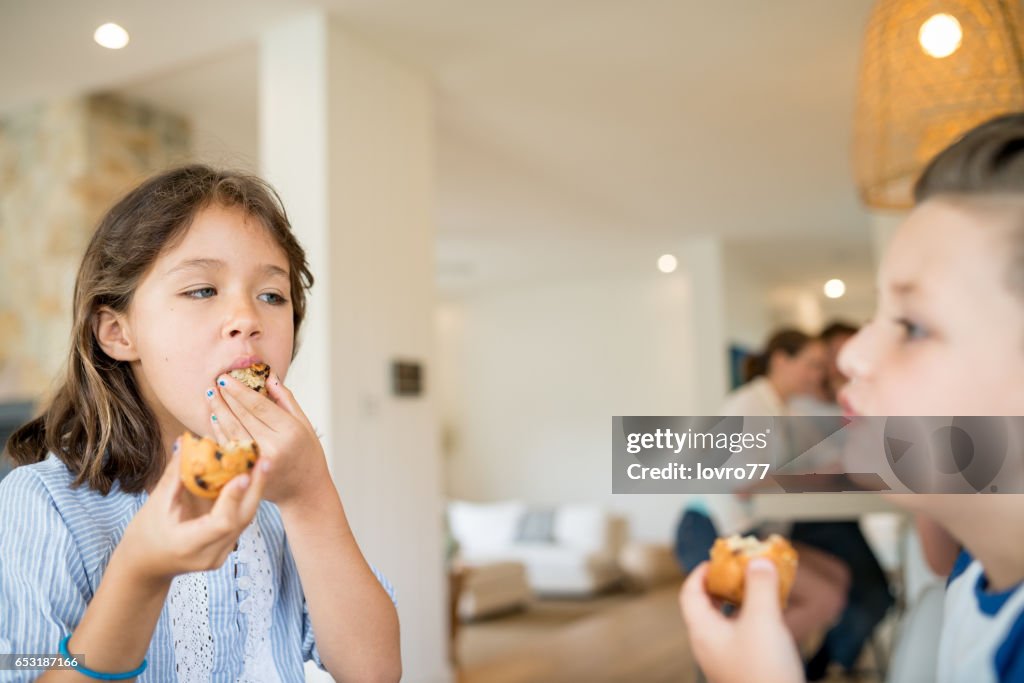 Brother and sister enjoy fresh muffins