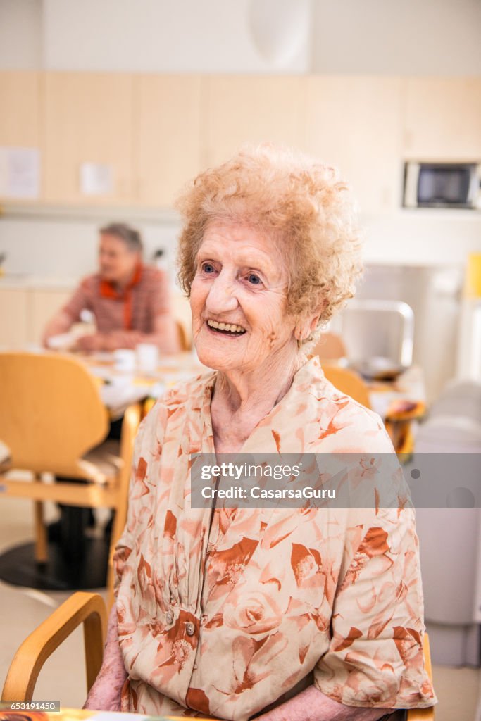 Senior Woman At The Nursing Home Sitting In The Dining Room