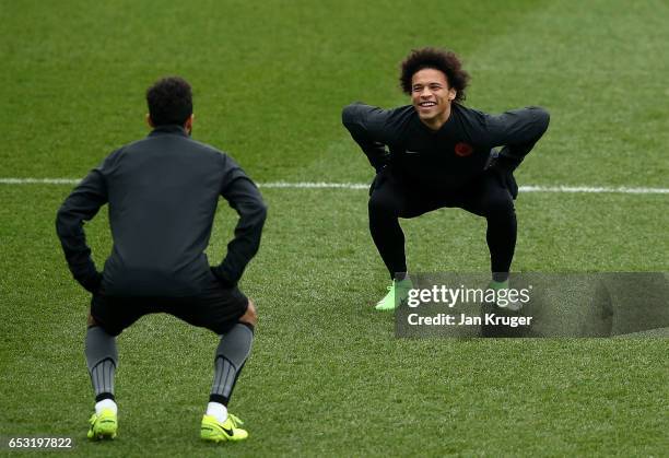 Gael Clichy of Manchester City and Leroy Sane of Manchester City share a smile during Manchester City training session prior to the UEFA Champions...