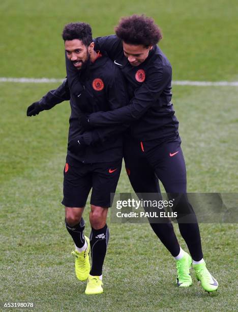 Manchester City's French defender Gael Clichy and Manchester City's German midfielder Leroy Sane take part in a training session at the City Football...