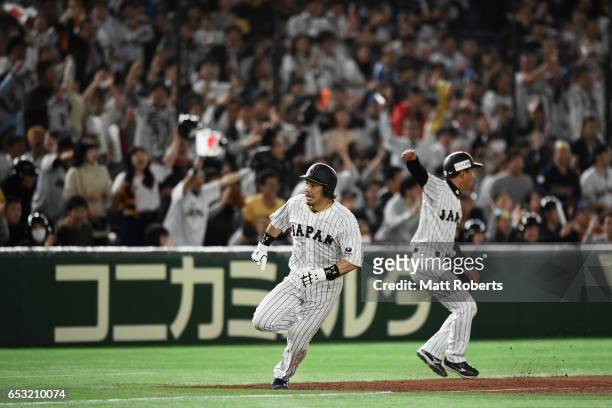 Infielder Nobuhiro Matsuda of Japan runs to the home plate to score a run to make it 5-5 by a RBI single of Catcher Seiji Kobayashi in the bottom of...