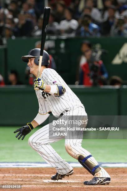 Catcher Seiji Kobayashi of Japan hits a RBI single to make it 5-5 in the bottom of the sixth inning during the World Baseball Classic Pool E Game...