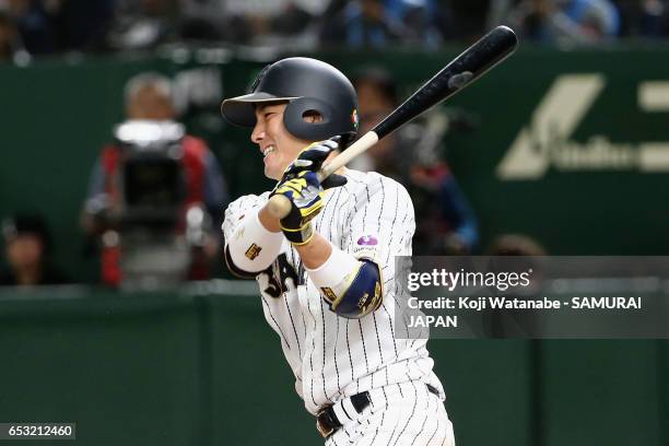 Catcher Seiji Kobayashi of Japan hits a RBI single to make it 5-5 in the bottom of the sixth inning during the World Baseball Classic Pool E Game...