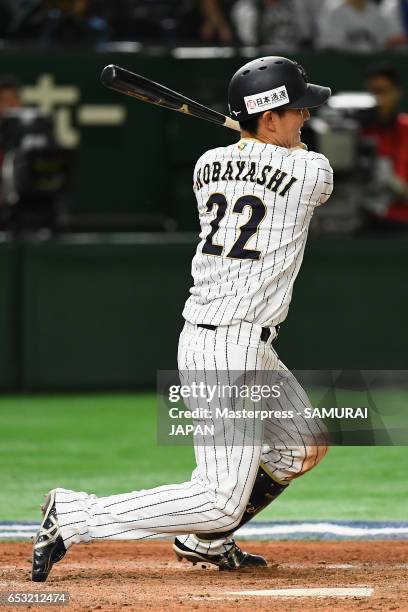 Catcher Seiji Kobayashi of Japan hits a RBI single to make it 5-5 in the bottom of the sixth inning during the World Baseball Classic Pool E Game...