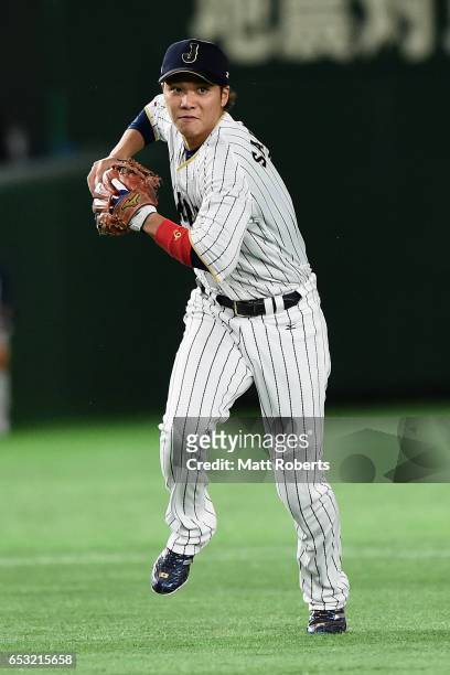 Infielder Hayato Sakamoto of Japan fields a grounder by Outfielder Roel Santos of Cuba in the top of the seventh inning during the World Baseball...
