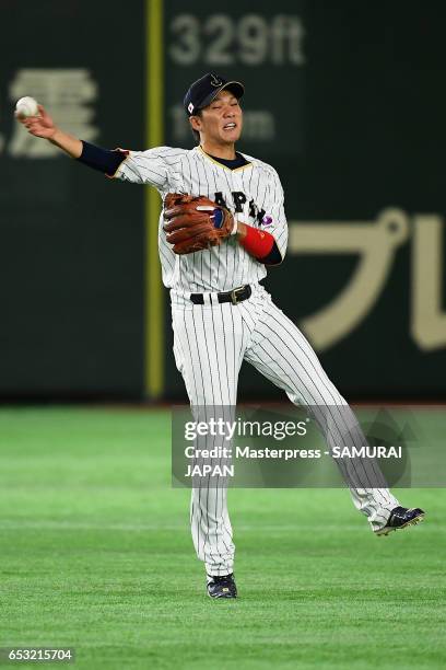 Infielder Hayato Sakamoto of Japan fields a grounder by Outfielder Roel Santos of Cuba in the top of the seventh inning during the World Baseball...