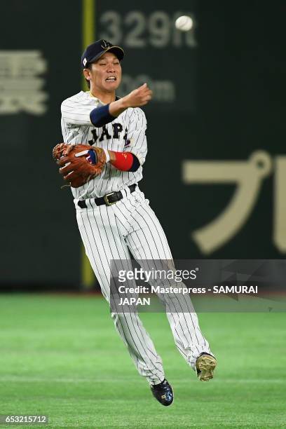 Infielder Hayato Sakamoto of Japan fields a grounder by Outfielder Roel Santos of Cuba in the top of the seventh inning during the World Baseball...