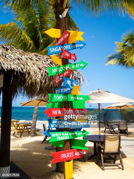 colorful signpost on a jamaican beach - jamaica foto e immagini stock