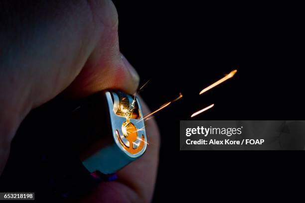 person hand lighting the lighter - lighter spark stock pictures, royalty-free photos & images