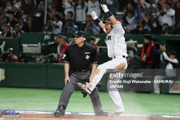 Infielder Nobuhiro Matsuda of Japan slides safely into the home plate to score a run to make it 5-5 by a RBI single of Catcher Seiji Kobayashi in the...