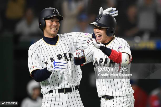 Designated hitter Tetsuto Yamada of Japan celebrates with Outfielder Shogo Akiyama after hitting a two run homer to make it 5-8 in the bottom of the...