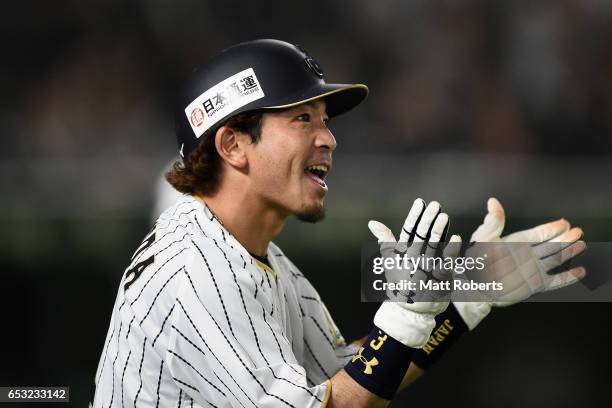 Infielder Nobuhiro Matsuda of Japan celebrates after scoring a run after a sacrifice fly by Pinch hitter Outfielder Seiichi Uchikawa to make it 5-6...