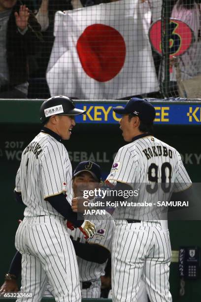 Pinch hitter Outfielder Seiichi Uchikawa of Japan is congratulated by Manager Hiroki Kokubo after hittin a sacrifice fly to make it 5-6 in the bottom...