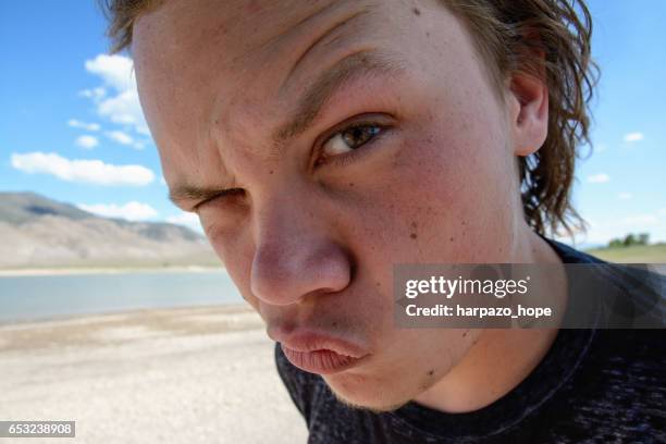 young man raising his eyebrow - asking face stock pictures, royalty-free photos & images