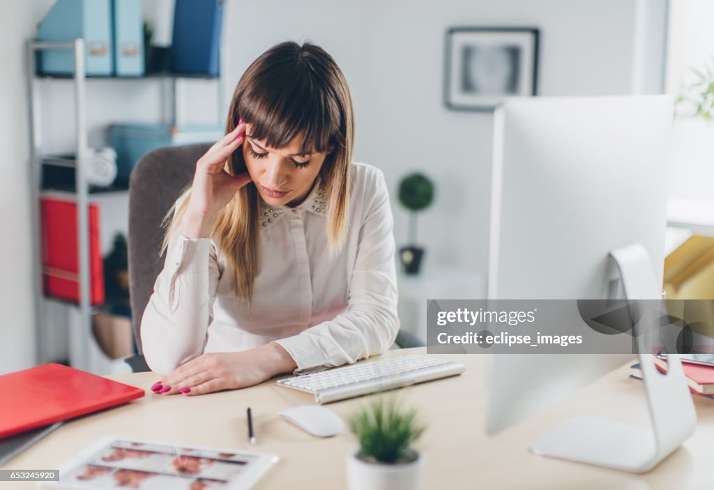 Stressed businesswoman in office