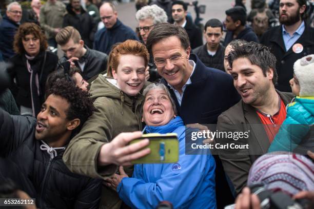 Dutch Prime Minister Mark Rutte takes a selfie photograph with supporters as he campaigns ahead of tomorrow's general election, on March 14, 2017 in...