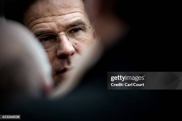 Dutch Prime Minister Mark Rutte talks to journalists as he campaigns ahead of tomorrow's general election, on March 14, 2017 in The Hague,...