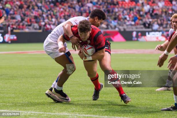 Adam Thomas of Wales fends off a tackle from Joe Perez of Samoa during day 2 of the 2017 Canada Sevens Rugby Tournament on March 12, 2017 in...