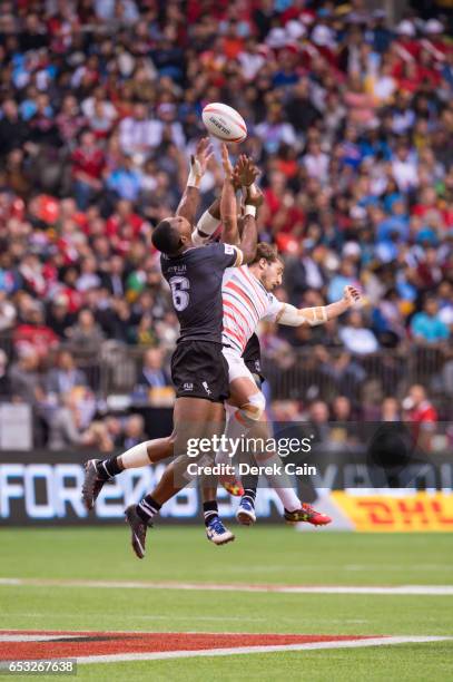 Mesulame Kunavula Vatemo Ravouvou of Fiji and Dan Bibby of England jump for the ball during day 2 of the 2017 Canada Sevens Rugby Tournament on March...