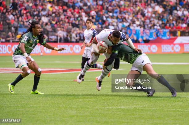 Andrew Durutalo of USA is tackled by Dylan Sage of South Africa during day 2 of the 2017 Canada Sevens Rugby Tournament on March 12, 2017 in...