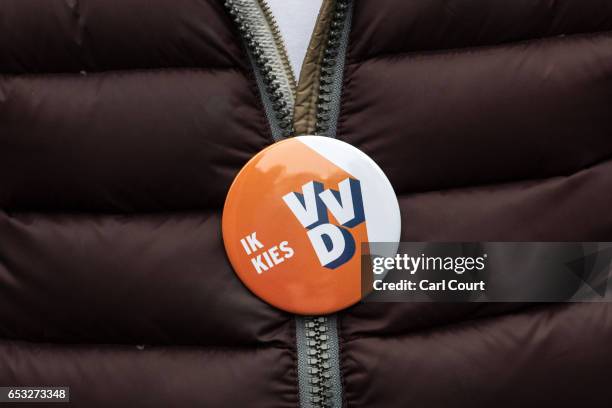 Man wears a VVD party badge during a campaign visit by Dutch Prime Minister Mark Rutte as he campaigns ahead of tomorrow's general election, on March...