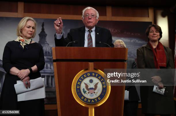 Sen. Bernie Sanders speaks as Sen. Kirsten Gillibrand and Sen. Amy Klobuchar look on during a news conference at the U.S. Capitol on March 14, 2017...