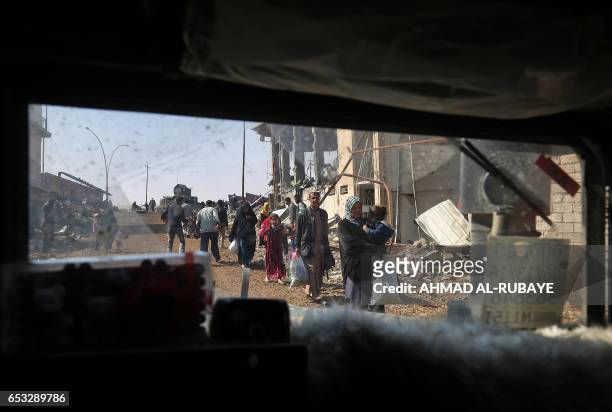 Displaced residents from Mosul's al-Nasser neighbourhood evacuate the area on March 14 as Iraqi forces continue to advance in the embattled city...