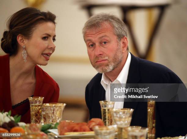 Russian businessman and billionaire Roman Abramovich listens to Polina Deripaska, the wife of billionaire Oleg Deripaska during the reception at the...